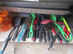lot 104 image: 4 wicker place mats, various kitchen utinsals includes spoons, wisk, can opener and more, 2 small orange cups