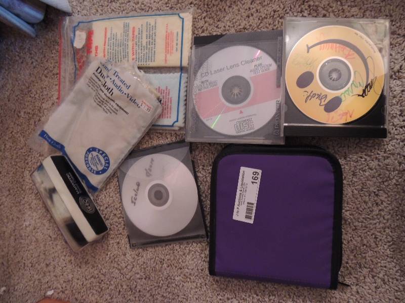 lot 169 image: Purple CD holder, CD lens cleaner a...