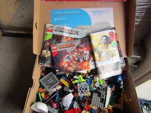 lot 64 image: Red box full of lego pieces and books for designs