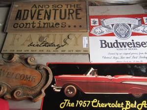 lot 101 image: Sign lot for indoor outdoor dcor- 913 welcome sign, 922   1957 chevolet bel-air, 1215 budweiser sign, 518 family birthday plaque, 919 And so the Adventure continues qty 5 signs