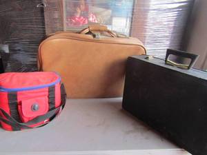 lot 122 image: Black brief case, brown luggage, red work lunch bag