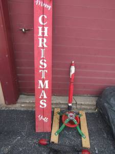 lot 37 image: Christmas tree stand,red solar lights and a merry Christmas porch sign