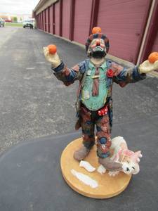 lot 126 image: Emmett Kelly limited edition clown with a white dog biting his shoe, the dogs tail is broke but comes with the broken piece