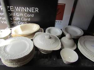 lot 149 image: Set of white vintage dishes, no name, lg serving bowl & platter, 11 saucers, sugar & creamer, cereal bowls qty 5,  fruit bowls qty 7 and more