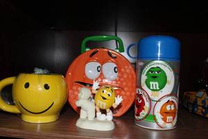 lot 111 image: Smilie face Cup, M&M Lunchbox and Thermos, and M&M Snowbabie Figurine