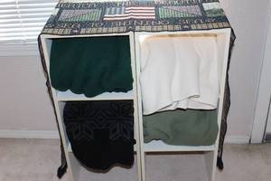 lot 221 image: Shelf with 4 Throw Blankets and Table Runner Shelves are 12x11.25x24 each