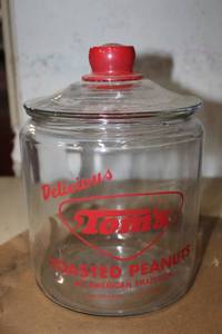 lot 71 image: Glass lidded canister reads Delicious Toms Toasted Peanuts
