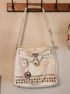 lot 18 image: Michael Kors studded hand bag