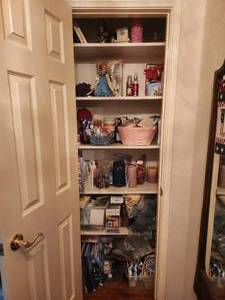 lot 310 image: Closet full of toiletries, candles and more.