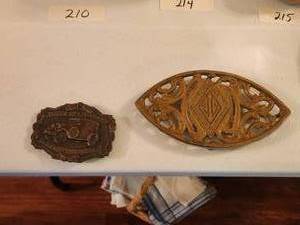 lot 213 image: Jewel Tea Company belt buckle(damaged) and trivet