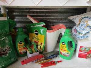 lot 158 image: used garden lot includes various plant food and soil, garden tools and more