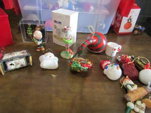 lot 51 image: Clear and red tote of various Christmas ornaments includes, Kentucky football and basketball, charlie brown, basketballs, and many more