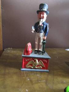 lot 54 image: 1154 Uncle Sam vintage METAL BANK, push the button and he drops a coin into the purse