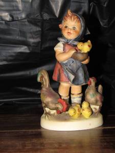 lot 116 image: Mj Hummel figurine from W. Germany- feeding time