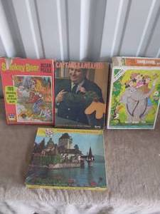 lot 104 image: Nice selection of Vintage Puzzles--Mickey Mouse, Smokey Bear, Captain Kangaroo and Scenic Picture