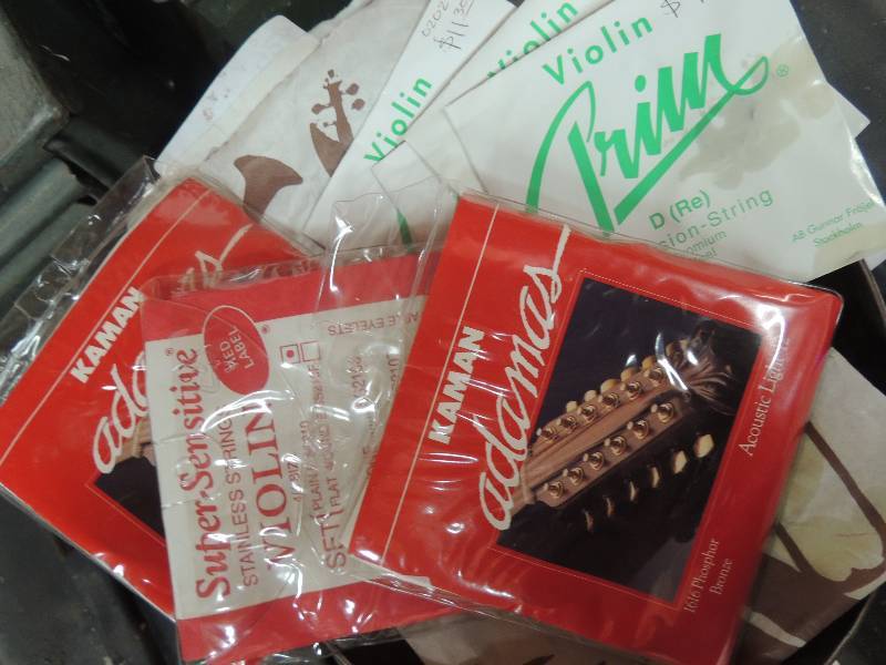 lot 925 image: Violin strings and guitar picks...