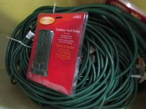lot 162 image: Tub of extension cords and outdoor stake plug