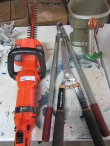 lot 177 image: Black & Decker -- 24 hedge trimmer, tree trimmers, Fiskars Shears and a seed spreader