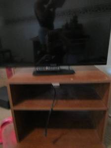 lot 237 image: 212414 rolling tv stand, comes with a 32 Panasonic tv with remote- unknown working condition