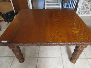 lot 1 image: Solid wood dining table square with 1 leaf, very beautiful carving designs ( see pics below) also comes with 4 very nice wooden chairs, description and pictures does this piece no justice 29 X 48 X 42,