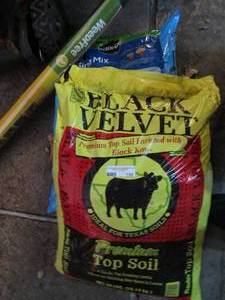 lot 195 image: New bag of potting soil and new roll of screen