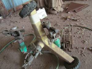 lot 847 image: vintage Hog foot trap and water sprinklers