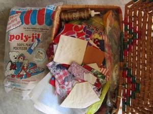 lot 485 image: bag of poly fill opened and used, wicker basket with lid full of fabric pieces
