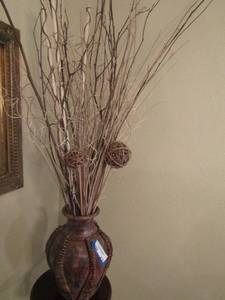 lot 313 image: 13 inch tall pottery vase with wicker on the outside with stick dcor inside