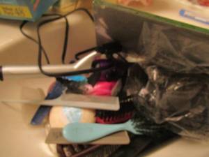 lot 390 image: tampax tampons, curling iron, combs and brushes, and more