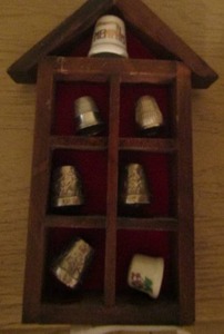 lot 53 image: thimbles qty 7 and a thimble holder