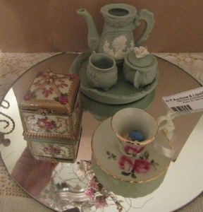 lot 139 image: circle mirror, mini green tea pot set, mini cup and plate and a trinket box