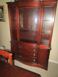 lot 319 image: China hutch 1 piece  size 69x48x15 has 3 draws 2 doors at the bottom, 1 large glass door Bassett furniture