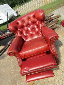 lot 53 image: LEATHER RECLINER Orange like leather recliner, has minor damage, very sturdy