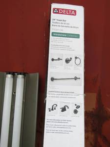lot 164 image: Delta kitchen faucet used in original box, Delta towel rack NIB, Delta bronze kitchen facet NIB- box is damaged