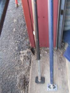 lot 219 image: 2 older load lock bars, 1 is Manuel crank and the other is hand twisted, used to keep items from falling and boxes when moving or loading into a truck