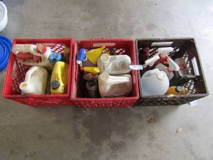 lot 246 image: 2 red and 1 black crate full of wheel cleaner, leather cleaner, coolant, bug stop, lighter fluid and more