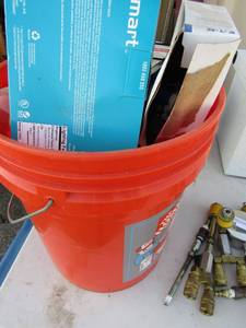 lot 440 image: orange utility bucket full of light bulbs and wall plugs