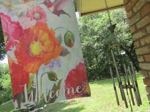 lot 876 image: humming bird flag with pole and wind chime