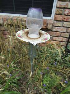 lot 897 image: 28 in home made bird feeder made out of wine bottle plate and flower vase