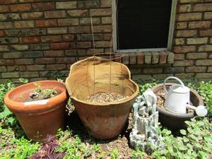 lot 931 image: plant potter, stone yard art and a water pal