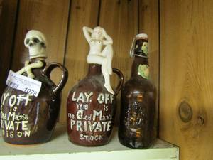 lot 1078 image: dcor bottles with ladies and skulls on top