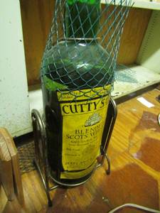 lot 1100 image: Cutty Sark blended scots whiskey bottle on stand 20 tall