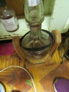 lot 1101 image: vintage jack Daniels bottle on wooden stand 14 tall
