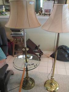 lot 1150 image: 2 metal floor lamps , 1 has a round oval glass table qty 2