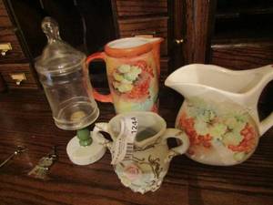 lot 1244 image: McCoy grape design pouring pitchers, covered canister on stand, doubled handled floral dcor vase