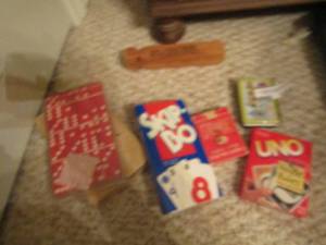 lot 1234 image: train whistle, playing cards, Uno, skip bo, dominoes