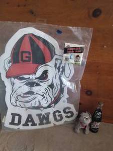 lot 89 image: Georgia Bulldogs Lot--Yard Sign, Coke Beanie Bulldog and Unopened Commemorative Coke Bottle from 1980