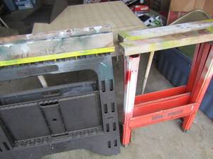 lot 127 image: 2 Black heavy duty plastic folding saw horses- 2 metal red folding saw horses qty total 4- 2 per set