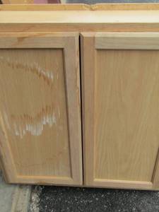 lot 152 image: 303013 blonde wood double door cabinet, damage will need repair
