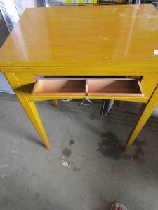 lot 159 image: Singer sewing table with machine inside, model # is AL820955, also has foot peddle appears to be in good condition-- 302317 closed-- with side open 304717